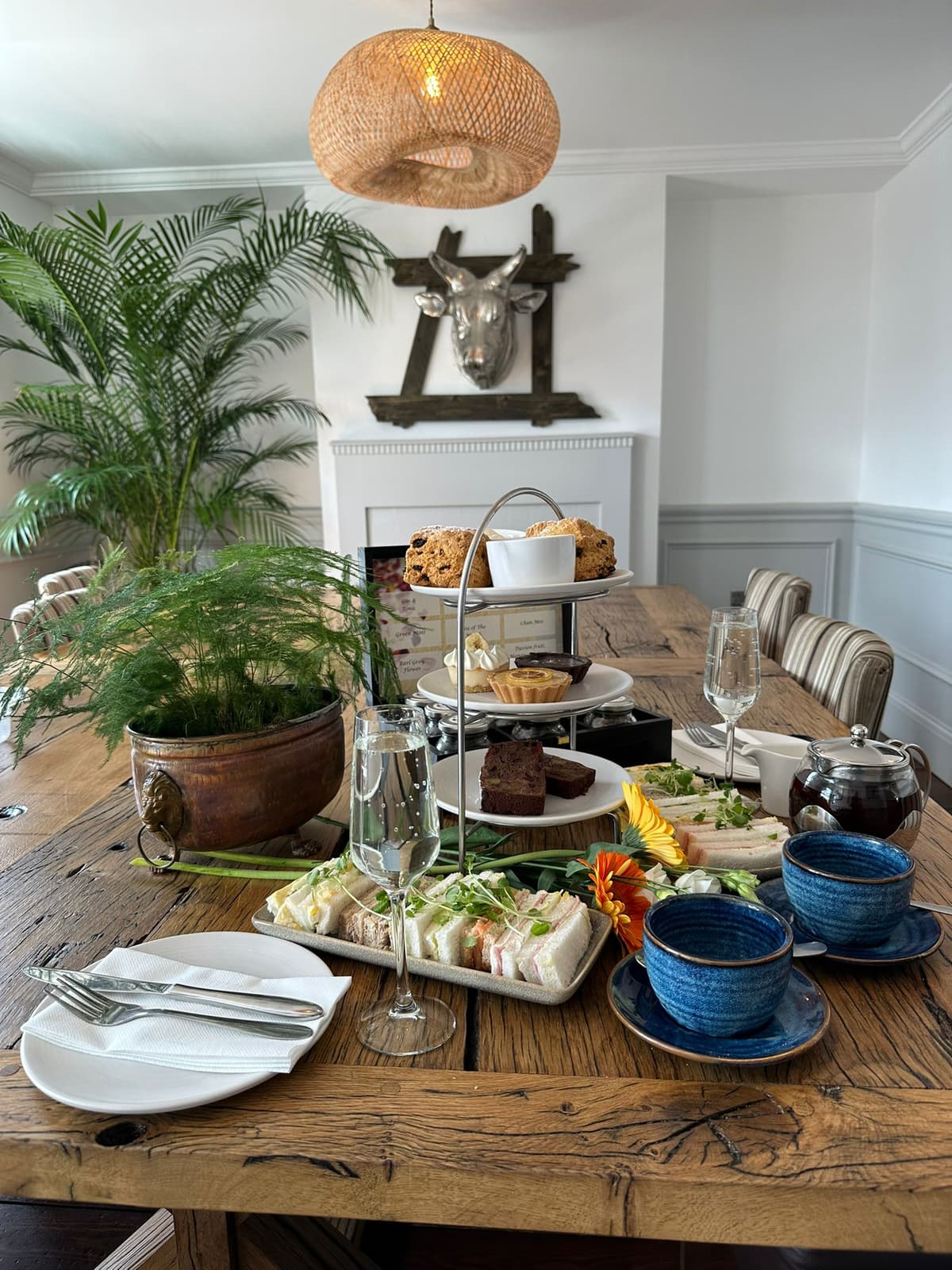 Exquisite afternoon tea service with tiered stands, fine china, and artisan pastries